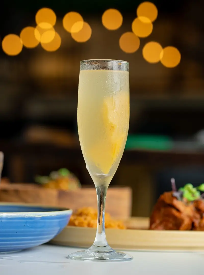 A mimosa in a tall flute at the bar