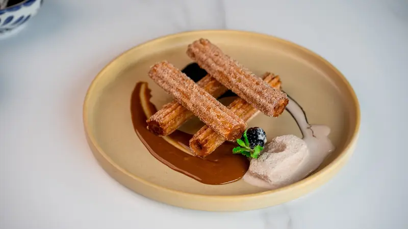 Churros with a caramel sauce and whipped cream